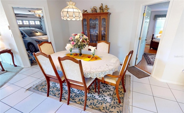 tiled dining room featuring a healthy amount of sunlight