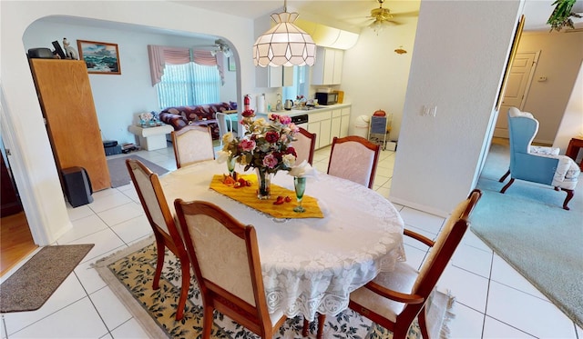 dining area with ceiling fan and light tile patterned flooring