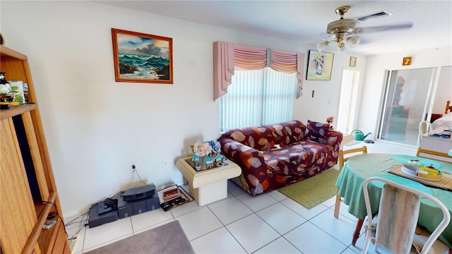 tiled living room featuring ceiling fan