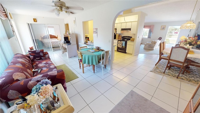 living room featuring ceiling fan and light tile patterned flooring