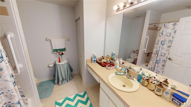 bathroom featuring tile patterned flooring, vanity, toilet, and curtained shower