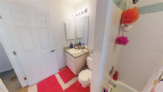 full bathroom with vanity, tiled shower / bath combo, and toilet