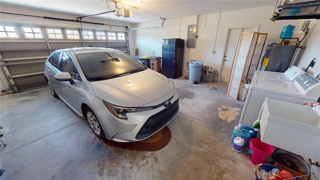 garage with a garage door opener, electric panel, black fridge, sink, and water heater