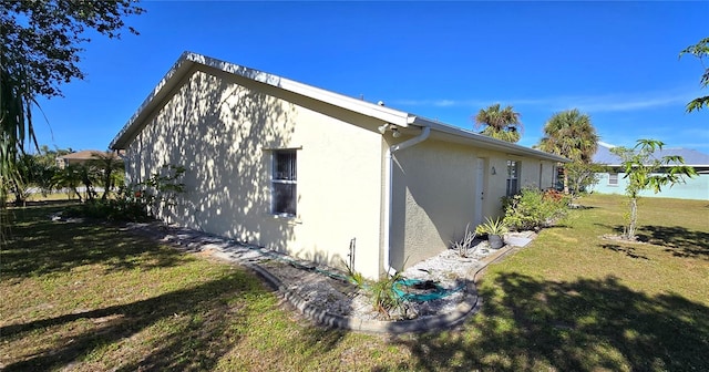 view of home's exterior with a lawn