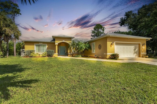 view of front facade with a garage and a lawn