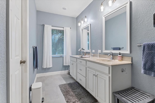 bathroom with tile patterned flooring and vanity