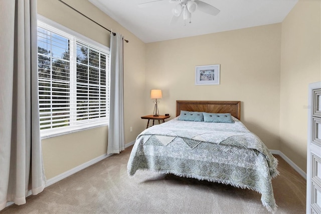 bedroom featuring ceiling fan and light carpet