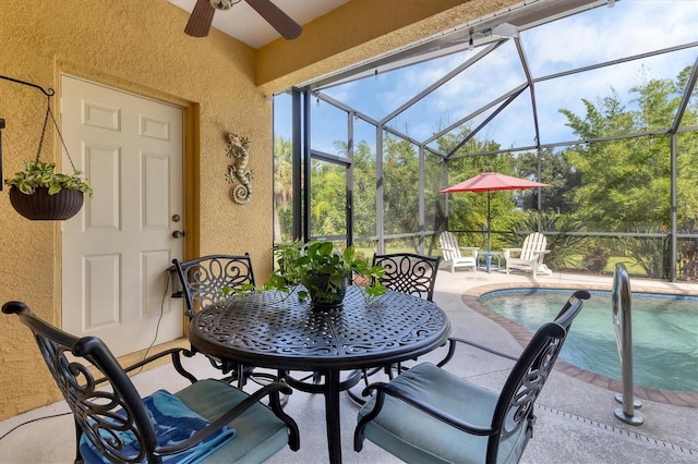 exterior space featuring glass enclosure and ceiling fan