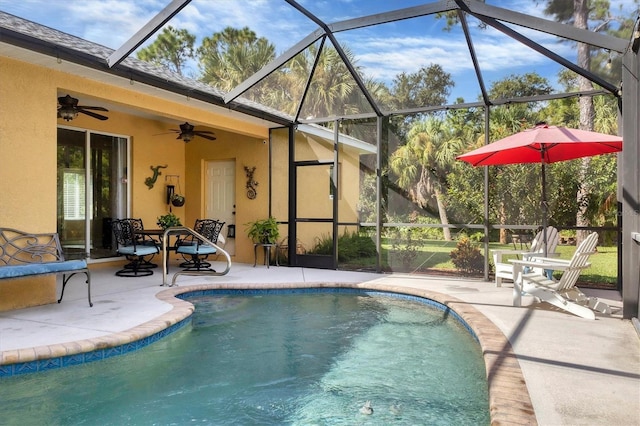 view of pool with a lanai, ceiling fan, and a patio area