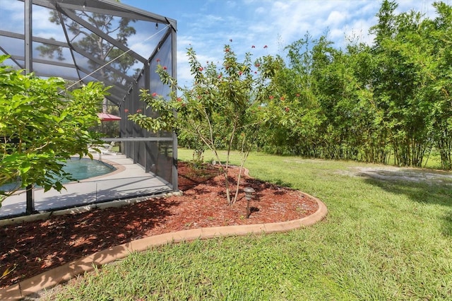 view of yard featuring glass enclosure