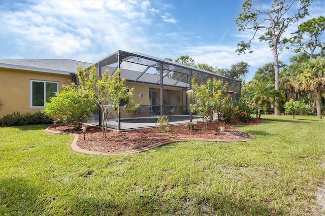 rear view of house featuring glass enclosure, a patio area, and a yard