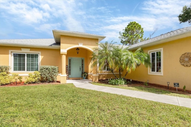 property entrance with a lawn