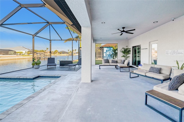 view of patio with glass enclosure, ceiling fan, a water view, and an outdoor hangout area