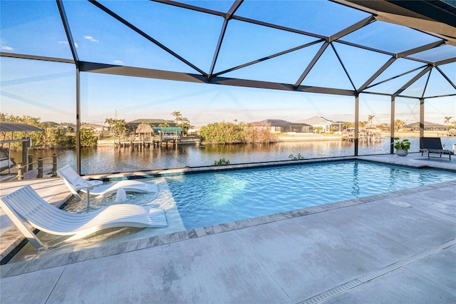 view of pool with a lanai, a patio, and a water view