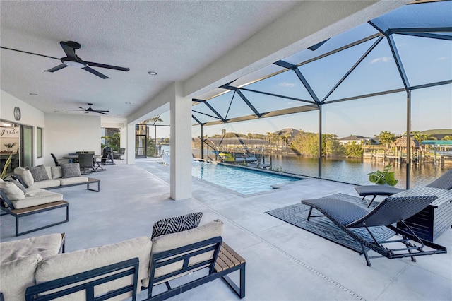 view of pool featuring a lanai, a patio area, and a water view