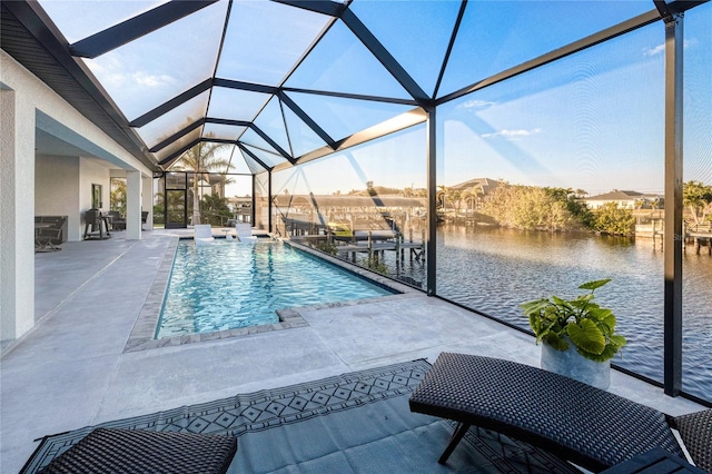 view of pool with a boat dock, a patio, a water view, and a lanai