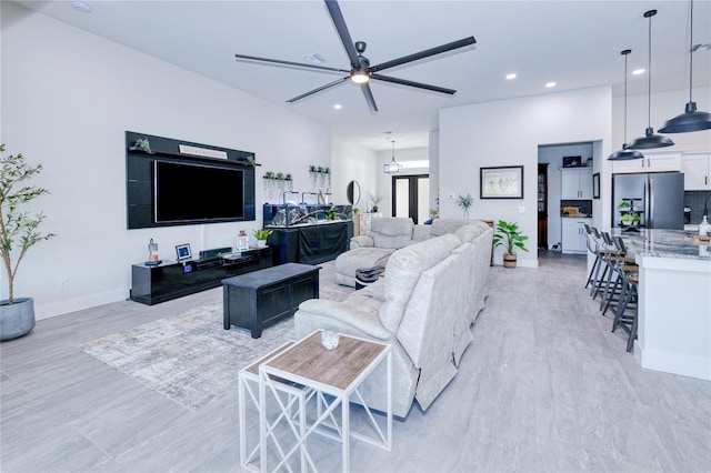 living room with light wood-type flooring and ceiling fan