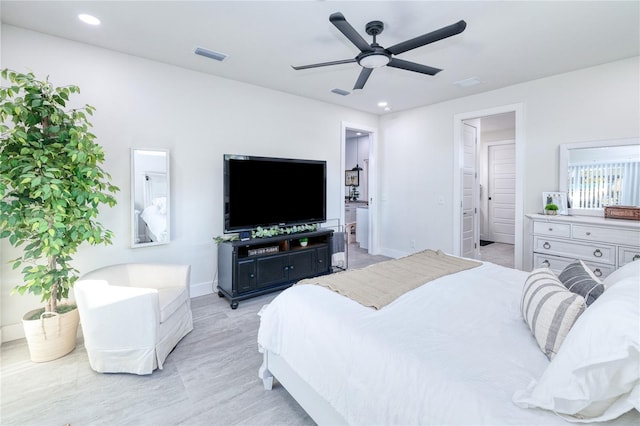 bedroom with ensuite bath and ceiling fan