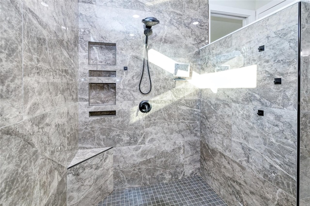 bathroom with tiled shower