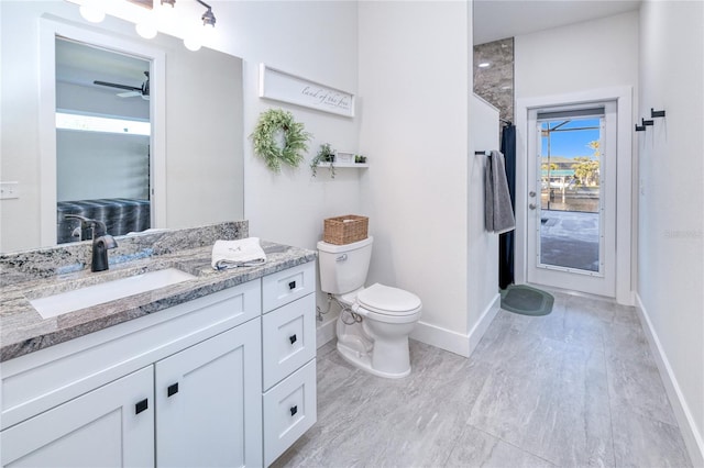 bathroom featuring curtained shower, ceiling fan, toilet, vanity, and hardwood / wood-style flooring