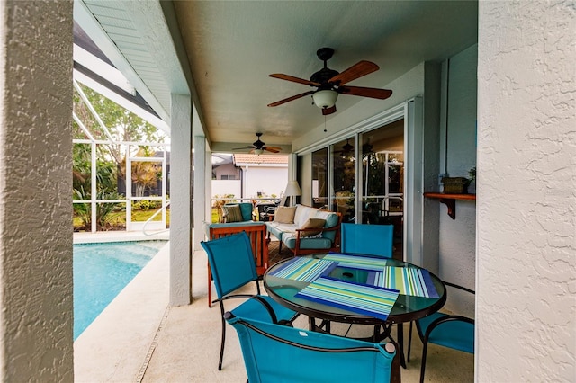 view of patio / terrace with a lanai and ceiling fan