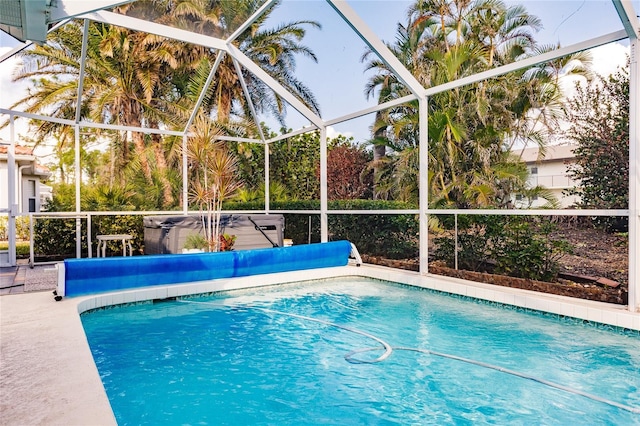 view of swimming pool featuring a lanai