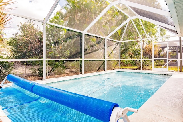 view of swimming pool with a lanai