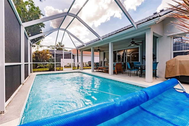 view of swimming pool with a lanai, outdoor lounge area, ceiling fan, a patio, and a grill