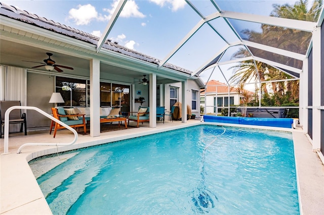 view of pool featuring an outdoor living space, a lanai, a patio, and ceiling fan