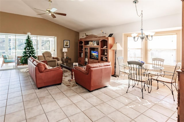 living room with vaulted ceiling, light tile patterned floors, and ceiling fan with notable chandelier