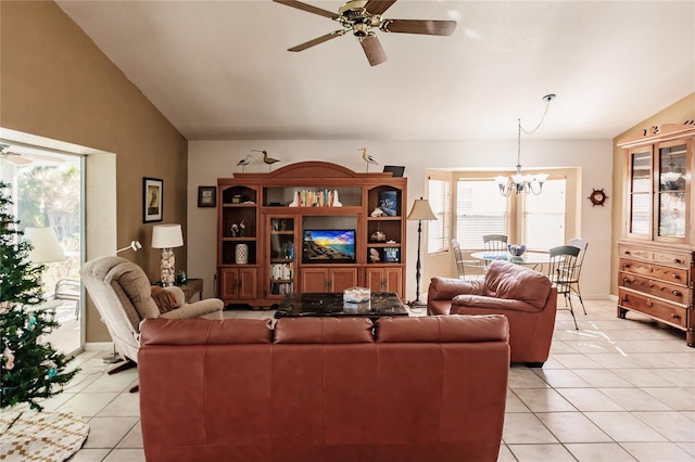 living room featuring ceiling fan with notable chandelier, light tile patterned flooring, and lofted ceiling