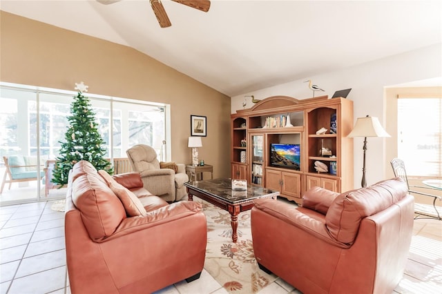 tiled living room with ceiling fan and lofted ceiling