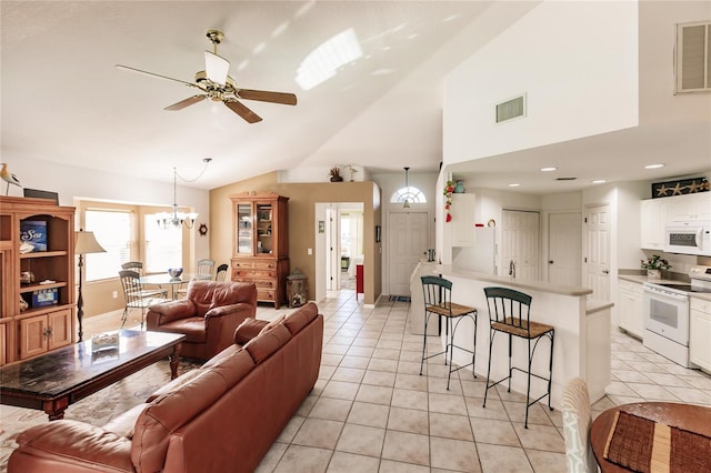 living room featuring ceiling fan with notable chandelier, vaulted ceiling, and light tile patterned flooring