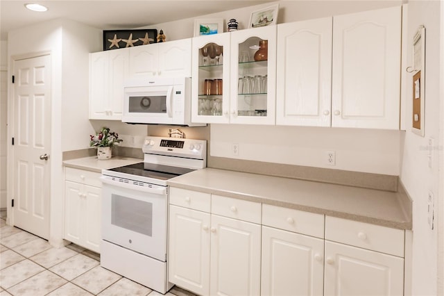 kitchen featuring white cabinetry, white appliances, and light tile patterned floors