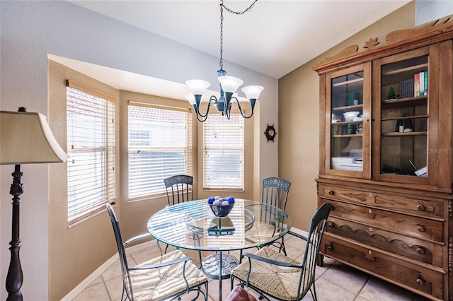 dining space featuring light tile patterned flooring, lofted ceiling, and a notable chandelier