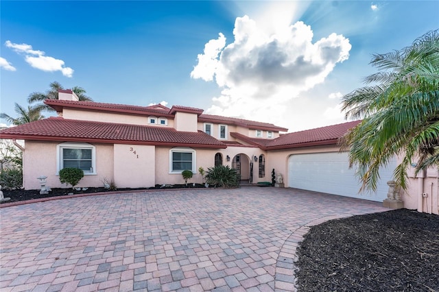 mediterranean / spanish-style home featuring a garage