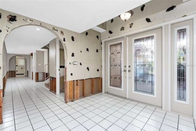 entryway featuring french doors and light tile patterned floors