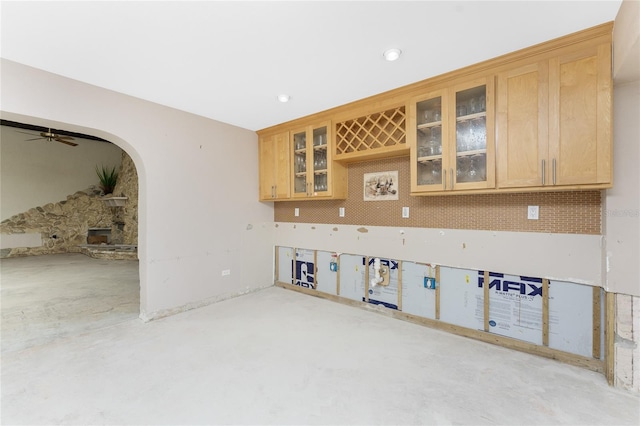 unfurnished room featuring a fireplace and ceiling fan