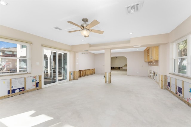 living room featuring a wealth of natural light and ceiling fan