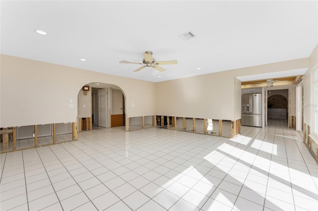 empty room with ceiling fan and light tile patterned flooring