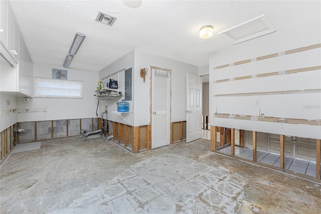 miscellaneous room with a textured ceiling