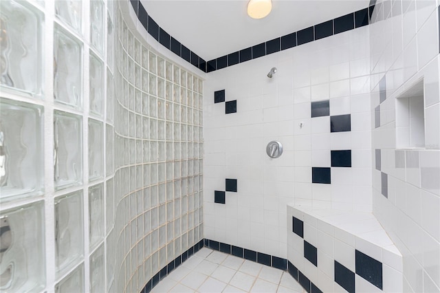 bathroom featuring a tile shower and tile patterned flooring