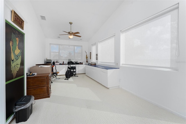 carpeted office space featuring ceiling fan and lofted ceiling