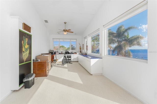 sunroom featuring a water view, lofted ceiling, and ceiling fan