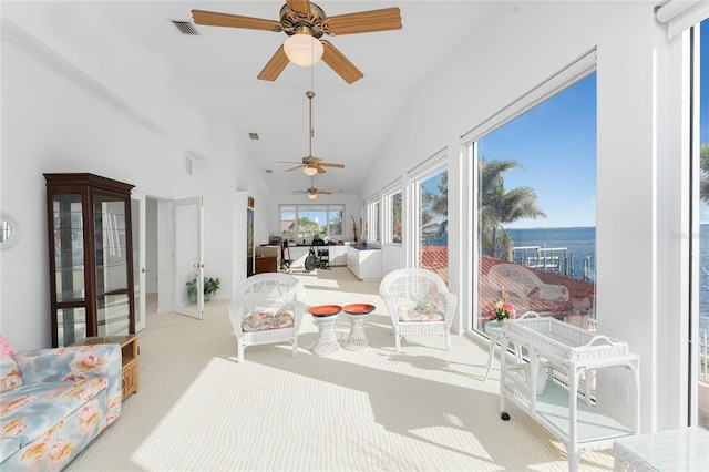 sunroom / solarium with a water view and lofted ceiling