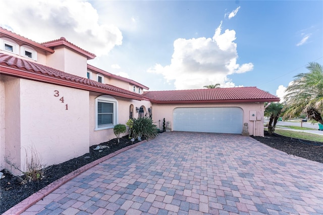 mediterranean / spanish house featuring a garage