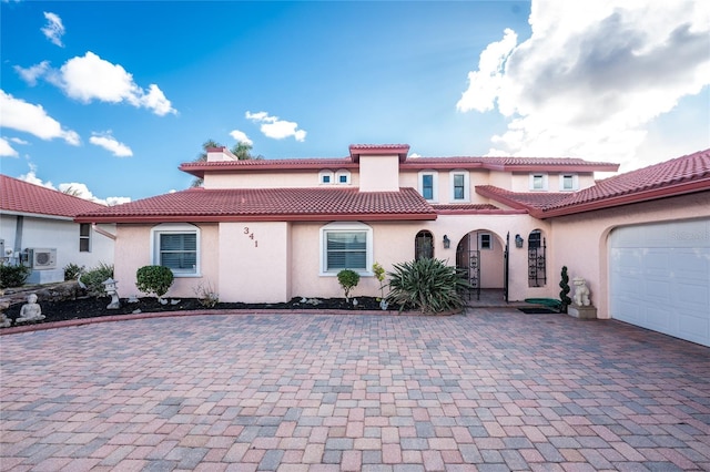 mediterranean / spanish-style house featuring a garage