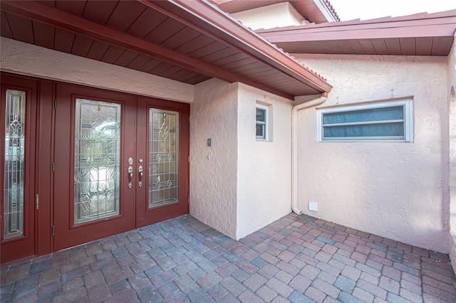 property entrance with french doors and a patio area