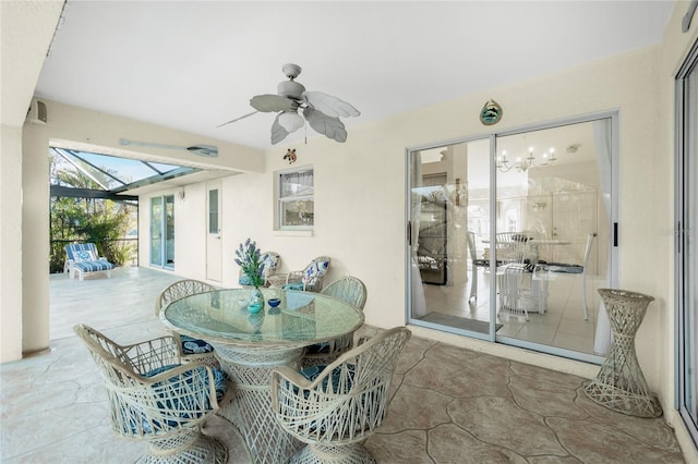 view of patio featuring glass enclosure and ceiling fan