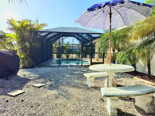 view of pool featuring glass enclosure